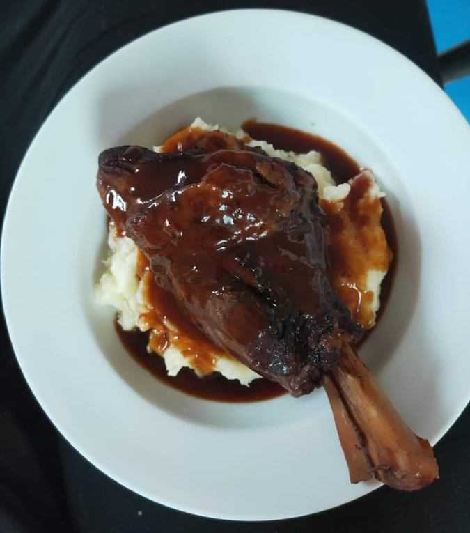 Slow Cooked Lamb Shanks In Red Wine Sauce On Mash Potato